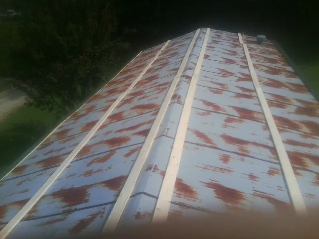 Rusted metal roof panels with new wood purlins before replacement — Storm Damage Roof Repair in Arvin by Roofing Brothers